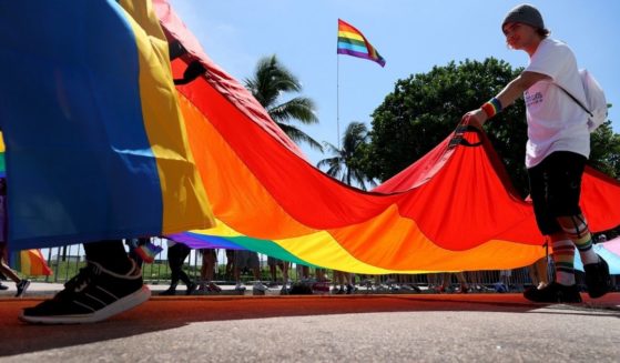 People carry the rainbow flag in the Miami Beach Pride Parade on Sept. 19, 2021, in Miami Beach, Florida.