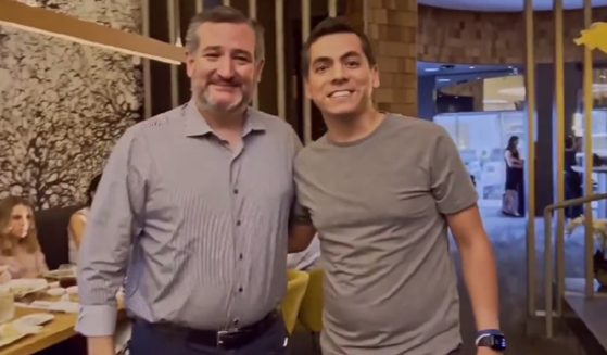 Texas Sen. Ted Cruz poses for a picture Friday with a man who turned out to be a leftist activist.