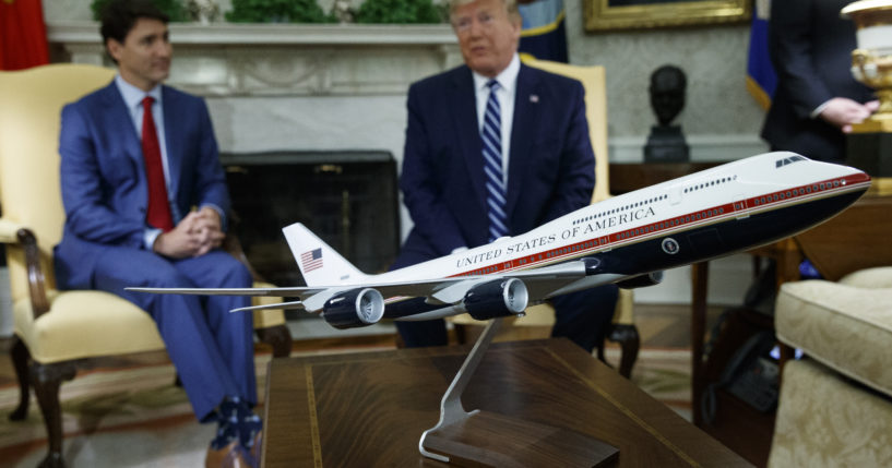 A model of the new Air Force One design sits on a table during a meeting between President Donald Trump and Canadian Prime Minister Justin Trudeau in the Oval Office of the White House, in this file photo from June 20, 2019. President Joe Biden's administration has scrapped former President Trump's red, white and blue design for the new generation of presidential aircraft after an Air Force review suggested it would raise costs and delay the delivery of the new jets.