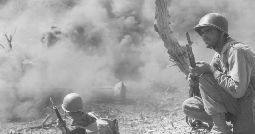 A member of the 503rd Parachute Infantry Regiment scouts out an area on Corragidor Island, Philippines, during World War II.