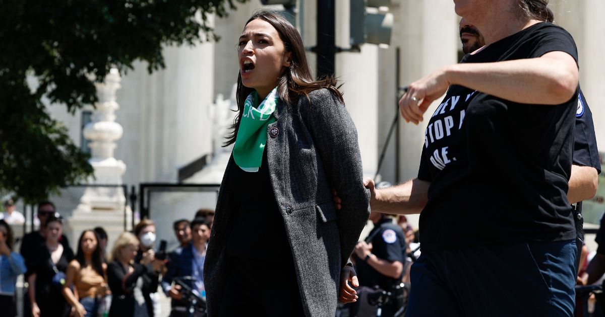Democratic Rep. Alexandria Ocasio-Cortez of New York is detained by U.S. Capitol Police after participating in a pro-abortion protest in front of the U.S. Supreme Court Building in Washington on Tuesday.