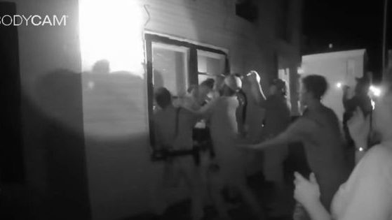 Body-cam footage from a Madison, Indiana, police officer shows the group of officers that gathered beneath a burning apartment's window to catch leaping survivors on July 3.