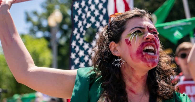 A pro-abortion activist chants in front of the White House on Monday in Washington, D.C.