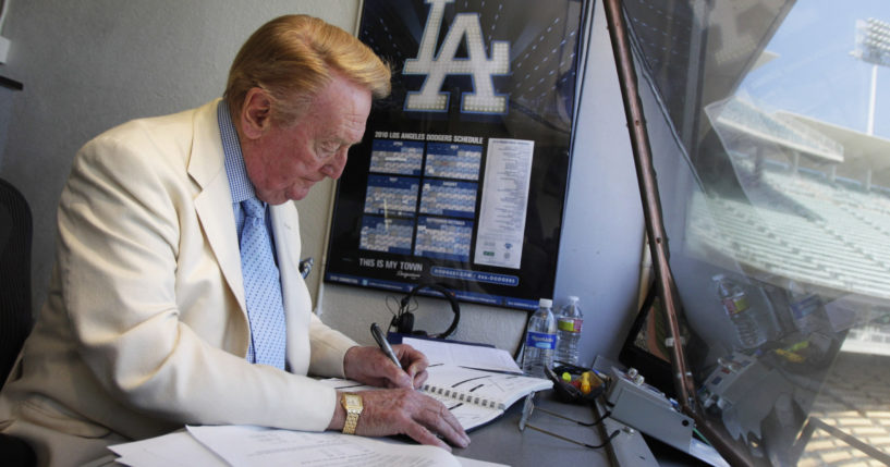 Vin Scully works in his booth at Dodger Stadium in Los Angeles on Aug. 22, 2010. Scully died Tuesday night.