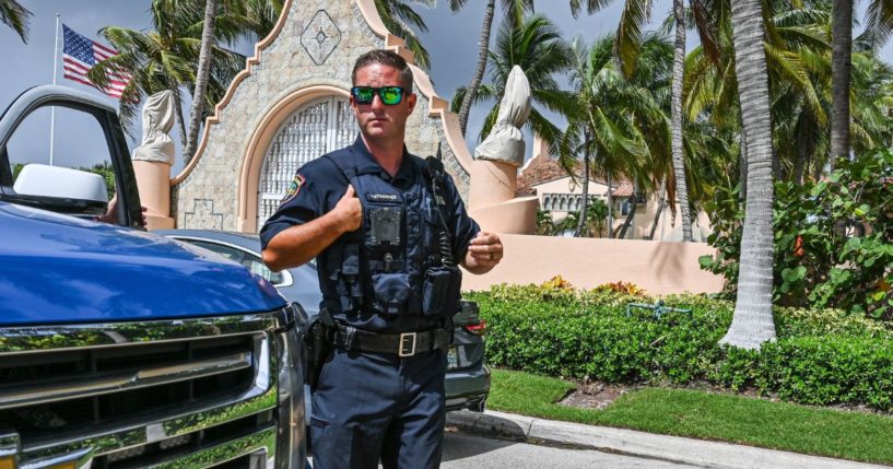 Local law enforcement officers are seen in front of the home of former President Donald Trump at Mar-A-Lago in Palm Beach, Florida, on Tuesday.