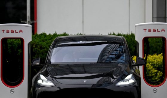 A Tesla car charges at a charging station outside a Tesla store in Beijing on April 29.