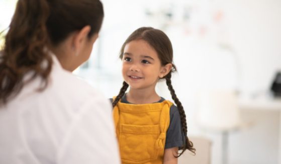 A young girls seeing a female doctor.