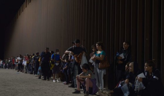 Migrants wait to be processed by Border Patrol after illegally crossing the U.S.-Mexico border in Yuma, Arizona, on July 11.