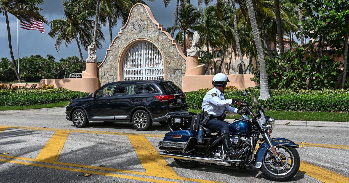 Local law enforcement officers are seen in front of the home of former President Donald Trump at Mar-A-Lago in Palm Beach, Florida, on Tuesday.