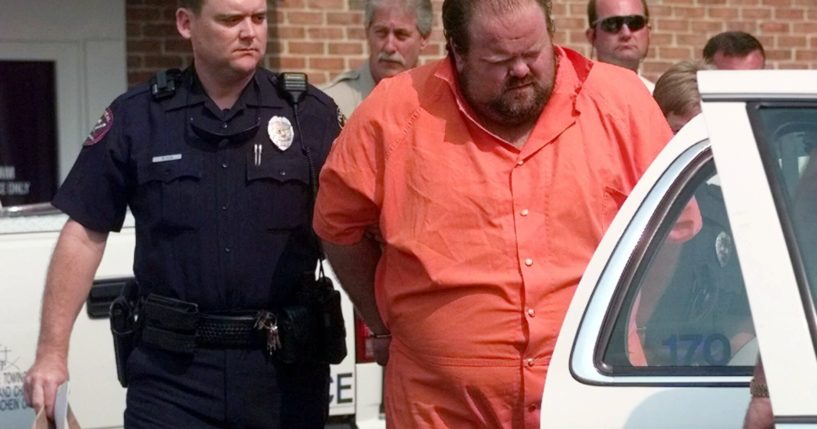 Officials escort murder suspect Alan Miller from the Pelham City Jail in Alabama on Aug. 5, 1999. Miller was scheduled to be put to death by lethal injection on Thursday for a workplace shooting rampage in 1999 that killed three men.