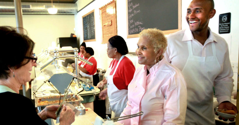 A customer picks up food from Sweetie Pie's owner Robbie Montgomery.