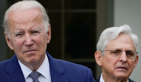 Attorney General Merrick Garland, right, looks on as President Joe Biden speaks in the Rose Garden of the White House in Washington on May 13.