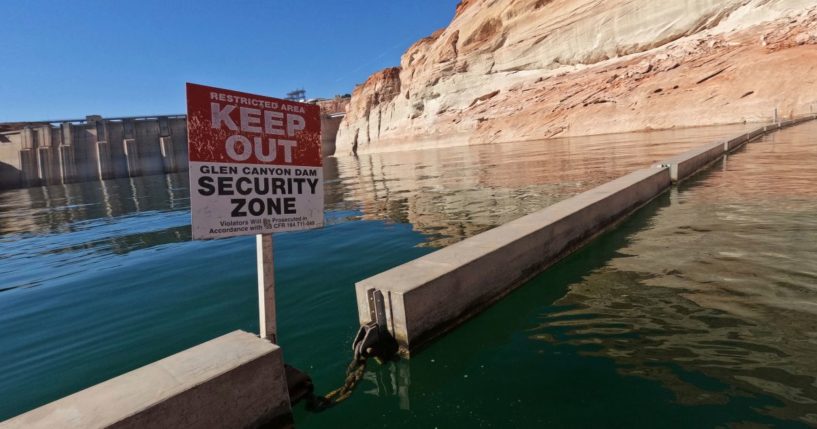 A "Keep Out" sign is displayed just upstream of Glen Canyon Dam at Lake Powell in Page, Arizona, on June 8, as America's large reservoirs on the Colorado River drop to record-low levels.