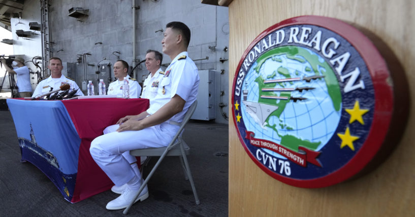 Rear Adm. Michael Donnelly, commander of the carrier strike group, second from right, listens to a reporter's question during a news conference on the deck of the nuclear-powered aircraft carrier USS Ronald Reagan in Busan, South Korea.