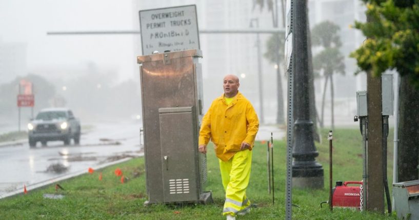 An emergency worker works deploys a generator to power a traffic signal as Hurricane Ian approaches on September 28, 2022 in Sarasota, Florida. Ian made landfall this afternoon, packing 150-mile-per-hour winds and a 12-foot storm surge and knocking out power to nearly 1.5 million customers, according to published reports. (Photo by Sean Rayford/Getty Images)