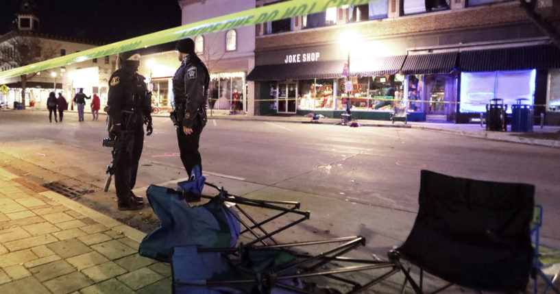 Police stand on W. Main Street in downtown Waukesha, Wisconsin, after an SUV drove through a Christmas parade on Nov. 21, 2021.