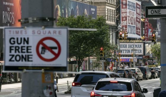A "Gun Free Zone" sign is posted near New York City's Times Square in this file photo from August. A federal judge said Thursday that New York gun rules which dramatically restrict where people can carry weapons and require concealed carry permit applicants to hand over social media information should be put on hold.