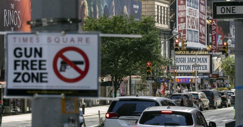 A "Gun Free Zone" sign is posted near New York City's Times Square in this file photo from August. A federal judge said Thursday that New York gun rules which dramatically restrict where people can carry weapons and require concealed carry permit applicants to hand over social media information should be put on hold.