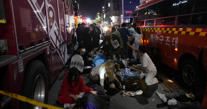 First responders and others attempt to help those who are injured after a crowd surge in Seoul, South Korea, on Saturday led to those attending the Halloween party to be crushed.