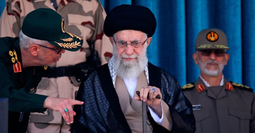 Iranian Supreme Leader Ayatollah Ali Khamenei, center, listens to Gen. Mohammad Hossein Bagheri during a graduation ceremony for a group of armed forces cadets at the police academy in Tehran on Monday.