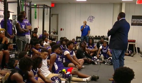 The football team for Mattie T. Blount High School in Mobile, Alabama, gathers for a pep talk.