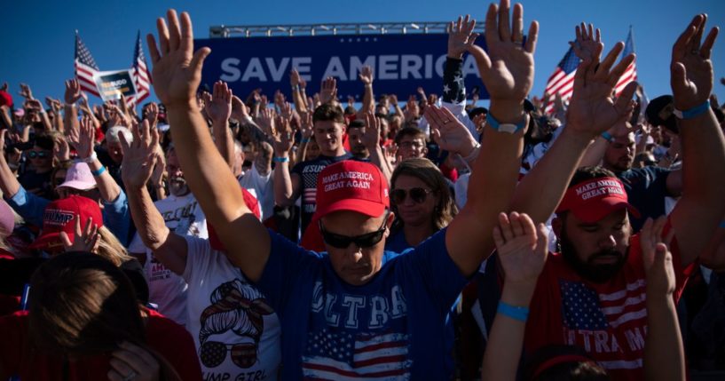 People pray before a rally for former President Donald Trump on Sept. 23 in Wilmington, North Carolina.