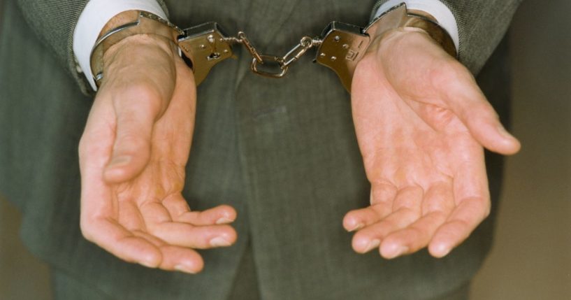 This stock image presents a businessman in cuffs.