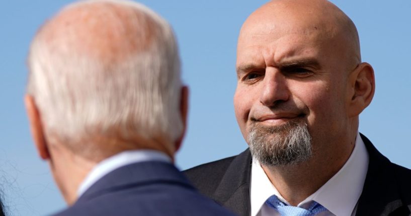 Pennsylvania Lt. Gov John Fetterman, a Democratic candidate for U.S. Senate, stands on the tarmac with President Joe Biden on Oct. 20.