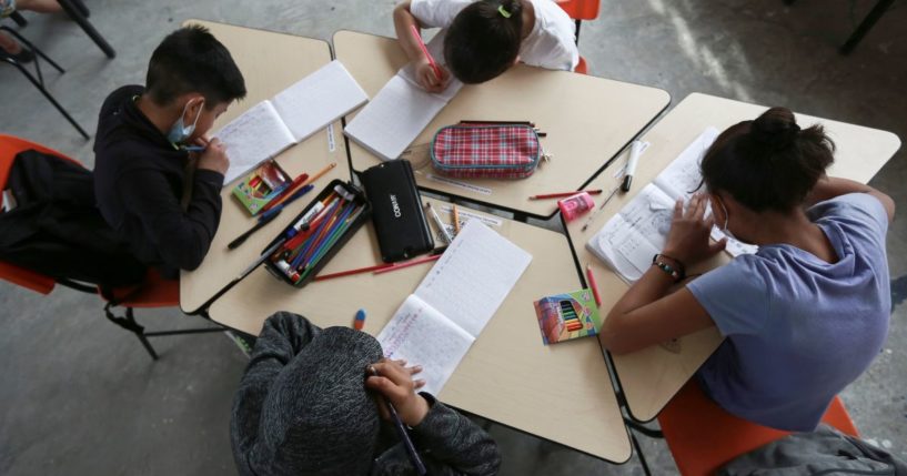 Migrant children work inside a classroom in Ciudad Juarez, Mexico, on March 28.