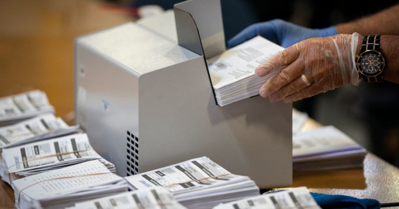 A canvasser processes mail-in ballots at the Anne Arundel County Board of Elections headquarters on Oct. 7 in Glen Burnie, Maryland.