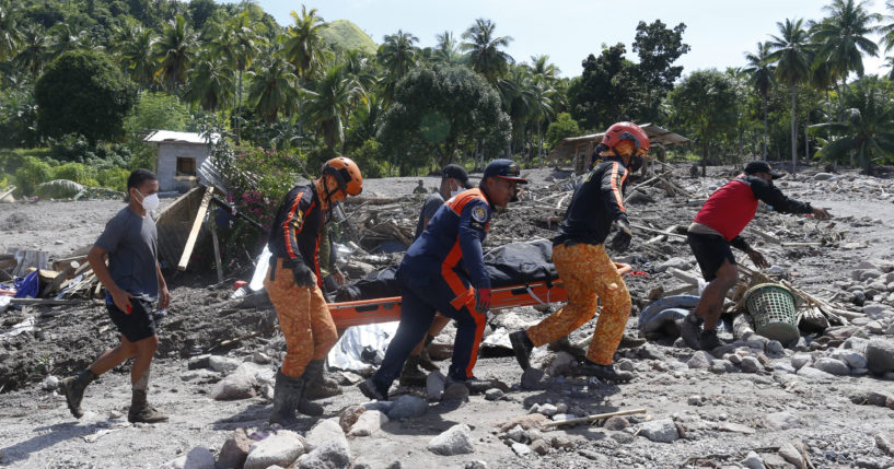 On Sunday, rescuers carry the body of a victim of mudslide in Maguindanao's Datu Odin Sinsuat town, Philippines.