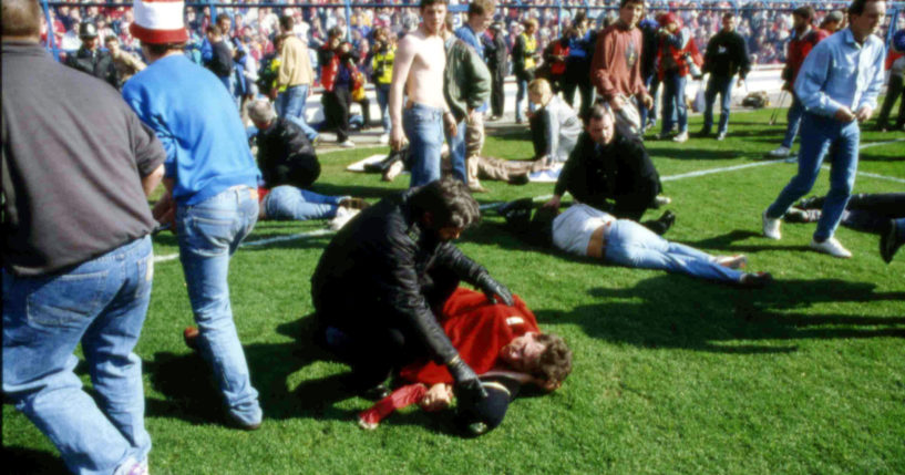 Stewards and supporters tend and care for wounded supporters on the field at Hillsborough Stadium, in Sheffield, England, on April 15, 1989.