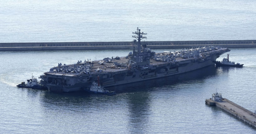 The U.S. carrier USS Ronald Reagan is escorted as it arrives in Busan, South Korea on Sept. 23.