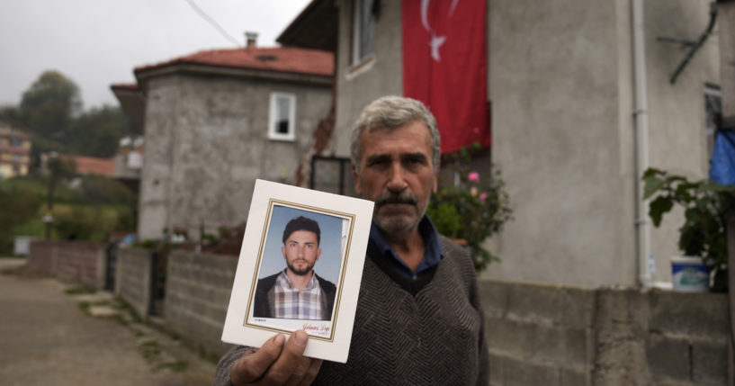 Recep Ayvaz, 62, shows a picture of his son, Selcuk Ayvaz, 33, one of the miners killed in a coal mine explosion, in front of his house in Amasra, in the Black Sea coastal province of Bartin, Turkey on Sunday.