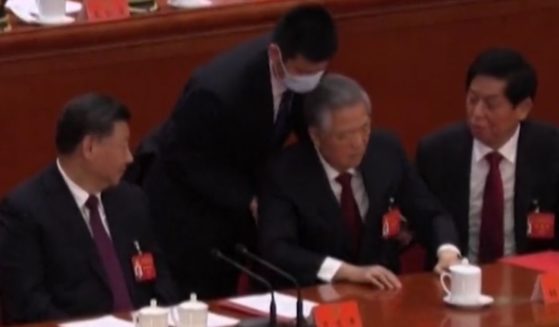 Former Chinese Hu Jintao is abruptly removed from a Communist party meeting in Beijing.