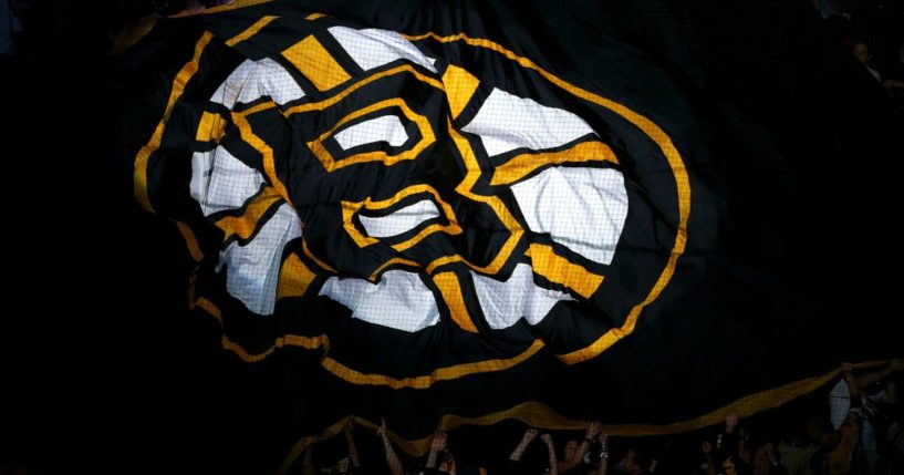 A Boston Bruins flag is passed over the crowd during introductions for Game Three of the 2013 NHL Stanley Cup Final between the Chicago Blackhawks and the Boston Bruins at TD Garden in Boston, Massachusetts, on June 17, 2013.