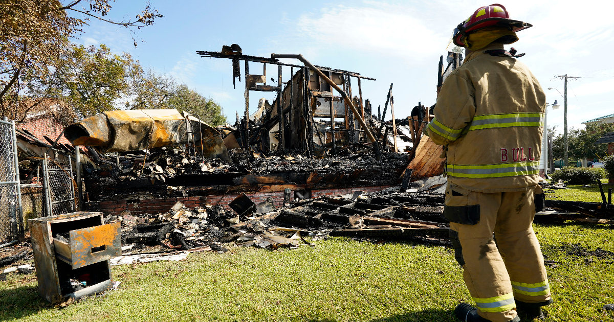 A firefighter observes the remains of a burned Epiphany Lutheran Church near midtown Jackson, Mississippi, on Tuesday.