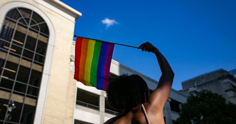 A person waves a rainbow flag on June 25 in Raleigh, North Carolina.