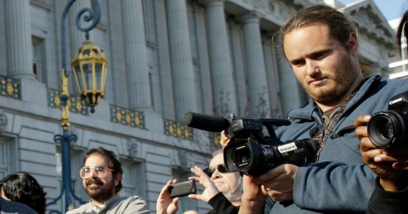 David DePape, right, records the wedding of Gypsy Taub outside City Hall in San Francisco on Dec. 19, 2013.