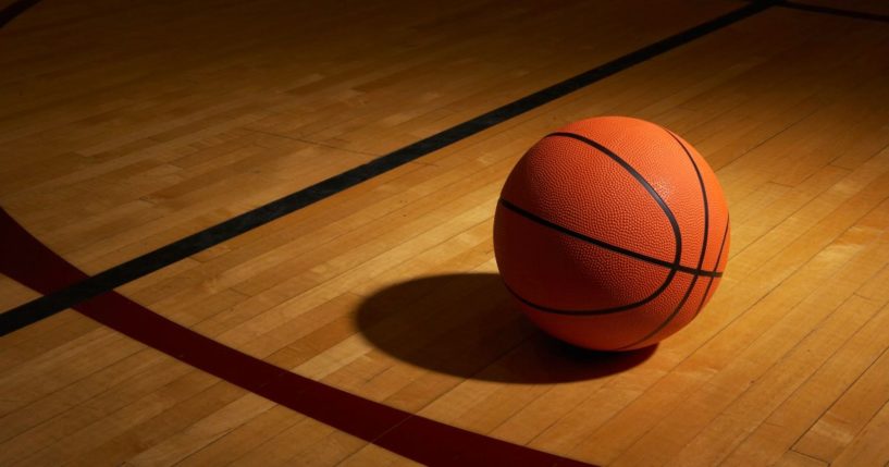 A basketball is shown on a basketball court.