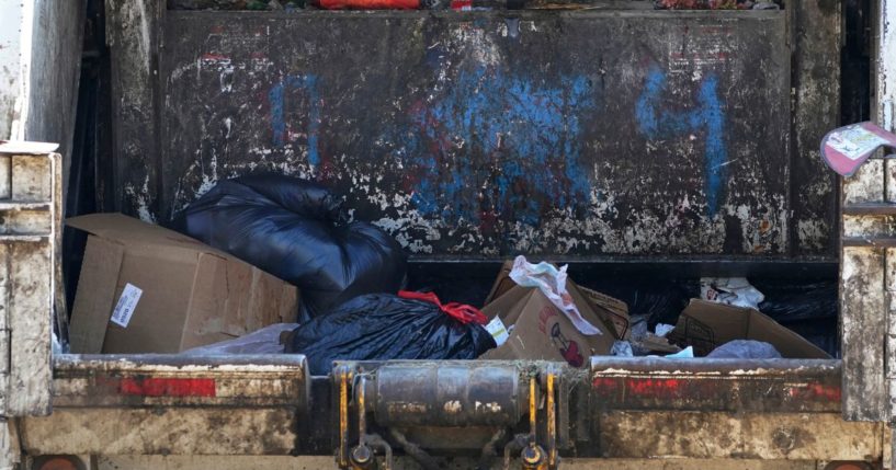 Residential garbage is put into the loading hopper of a trash truck in Jackson, Mississippi, on Oct. 7. In New Hampshire last week, a man was fortunate to find a treasure amid the trash at a transfer station.