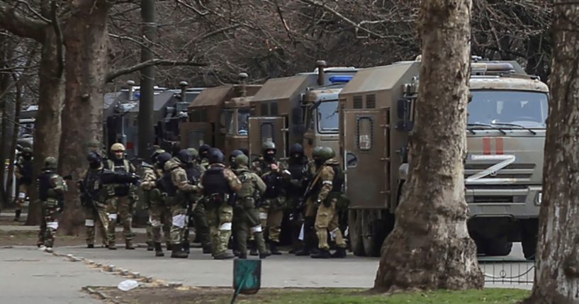 Russian army soldiers stand next to their trucks during a rally against Russian occupation in Svobody Square in Kherson, Ukraine, on March 7.