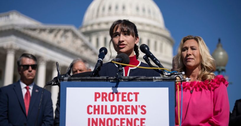 Chloe Cole speaks as Rep. Marjorie Taylor Greene looks on during a news conference on Capitol Hill Sept. 20 in Washington, D.C.