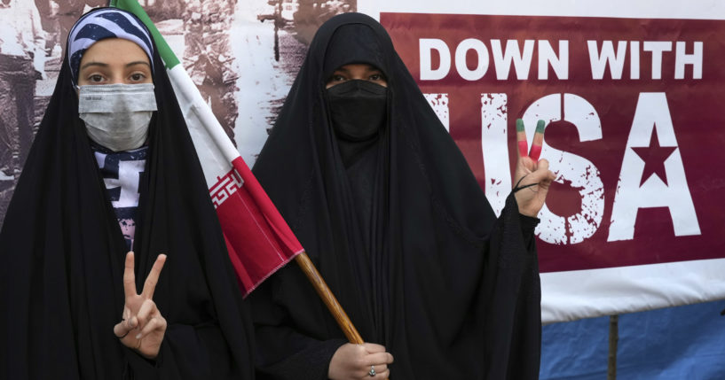 Iranian women flash a victory sign during an annual demonstration in front of the former U.S. Embassy in Tehran, Iran, on Friday.