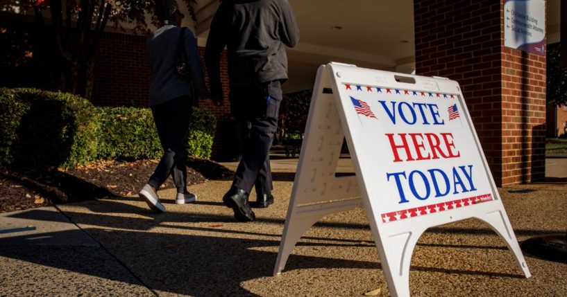 People walk into an early voting location on Thursday in Stafford, Virginia.