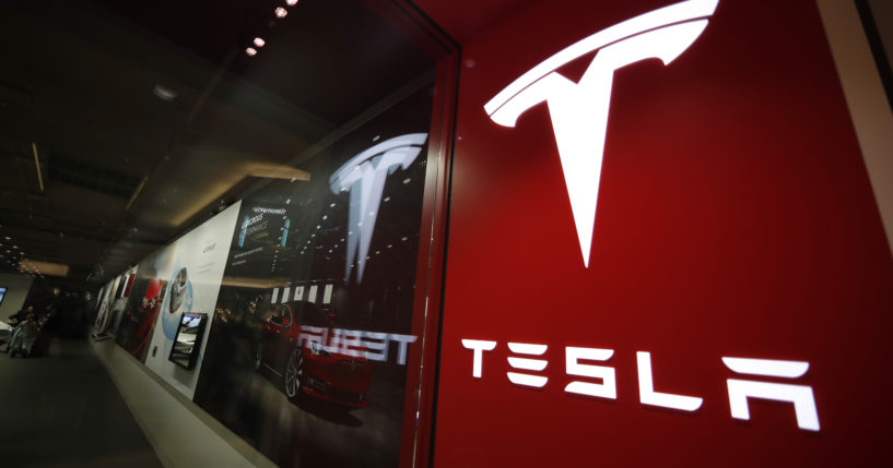 A sign bearing the company logo outside a Tesla store in Cherry Creek Mall in Denver, Colorado, is pictured on Feb. 9, 2019.