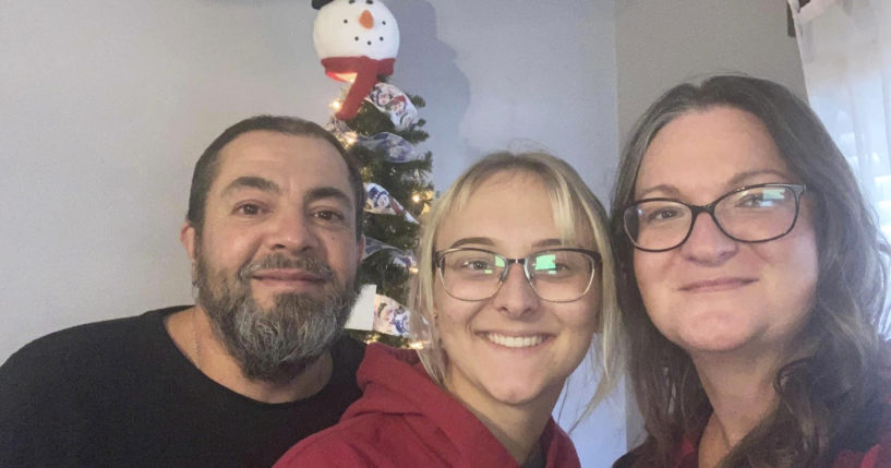 Pfc. Amiah Manlove, center, who is stationed with the U.S. Army in Oahu, Hawaii, poses with her mom Metika Beck Burke, right, and stepfather Stoney Burke, left, after she was finally able to make it home to Indianapolis on Sunday.