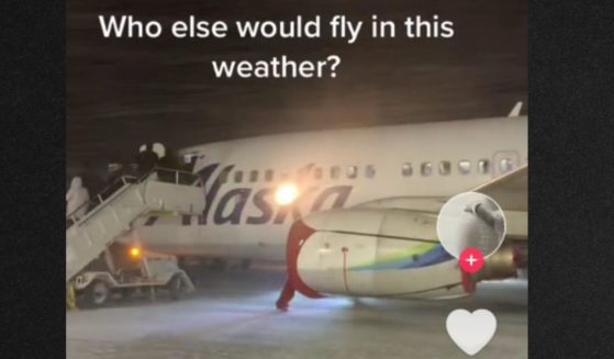 Passengers bundled up to board the plane from the tarmac in a fierce, windy snowstorm.