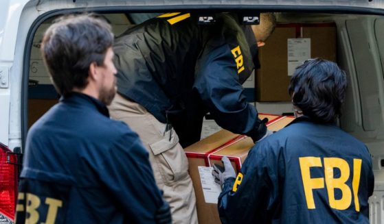 Federal agents load a vehicle with evidence boxes taken from a property related to Russian oligarch Oleg Deripaska in New York City on Oct. 19, 2021.