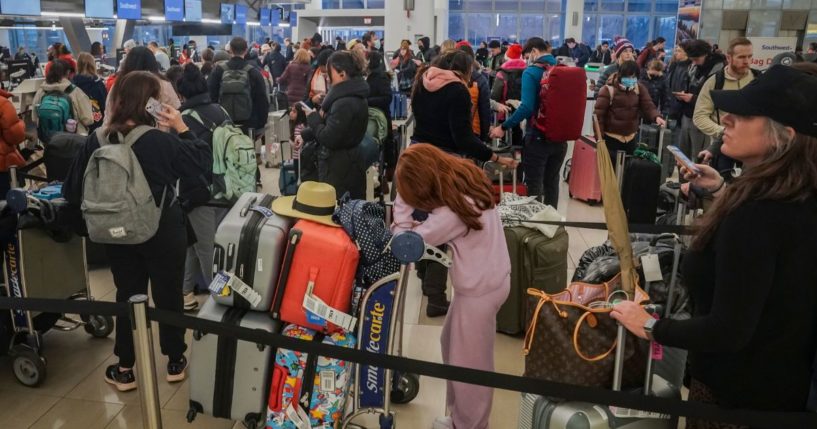 Southwest Airlines' passengers stand in lines during delays and cancellations at Laguardia Airport in New York City on Friday.